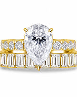 Pear cut moissanite ring in yellow gold with brilliant shoulder accents and elegant profile | SARATTI.