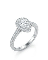 Pear shaped moissanite engagement ring with round halo and pavé shoulders crafted in platinum | SARATTI
