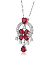 Pigeon blood ruby and diamond platinum pendant worn at the neckline | SARATTI
