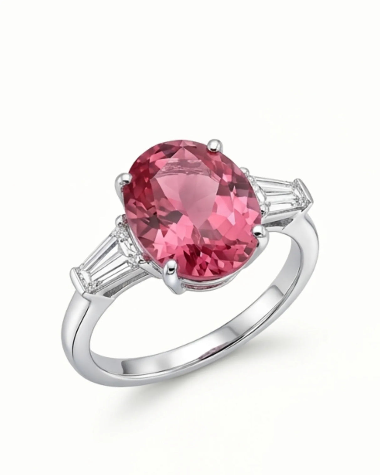 Pink tourmaline ring with oval center stone and emerald-cut diamonds in polished platinum | SARATTI