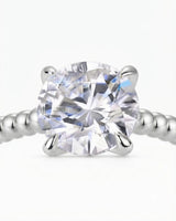 Platinum moissanite engagement ring for a refined proposal with distinctive beaded craftsmanship | SARATTI
