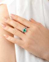 Platinum natural emerald engagement ring with moissanite halo, split shank, and curved wedding band | SARATTI.