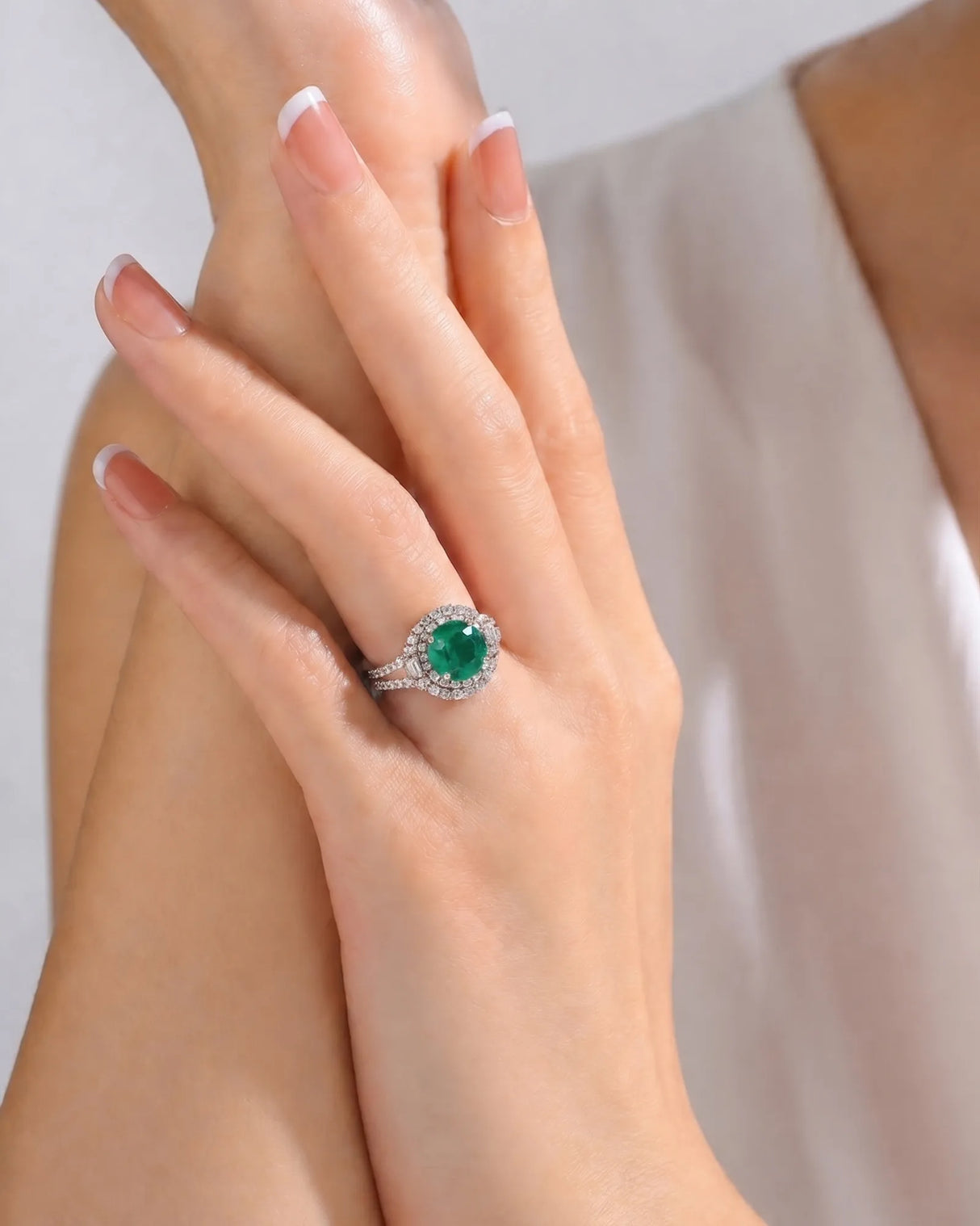 Platinum oval emerald ring with round and baguette diamond accents | SARATTI