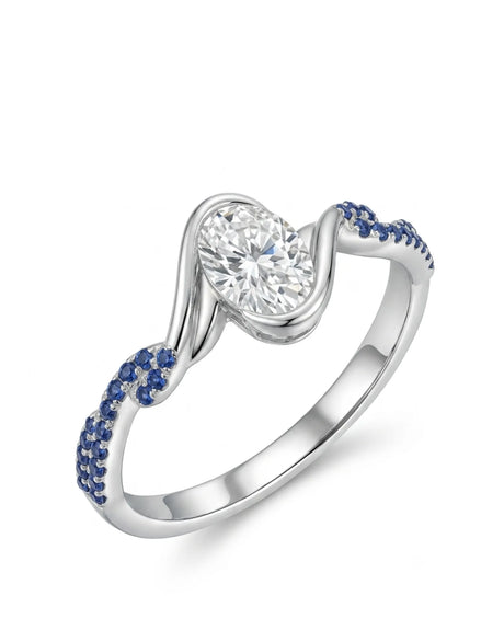 Platinum oval moissanite engagement ring with natural blue sapphire accents and flowing bezel design | SARATTI