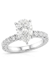 Platinum pear cut moissanite engagement ring with round side stones and slim polished band | SARATTI