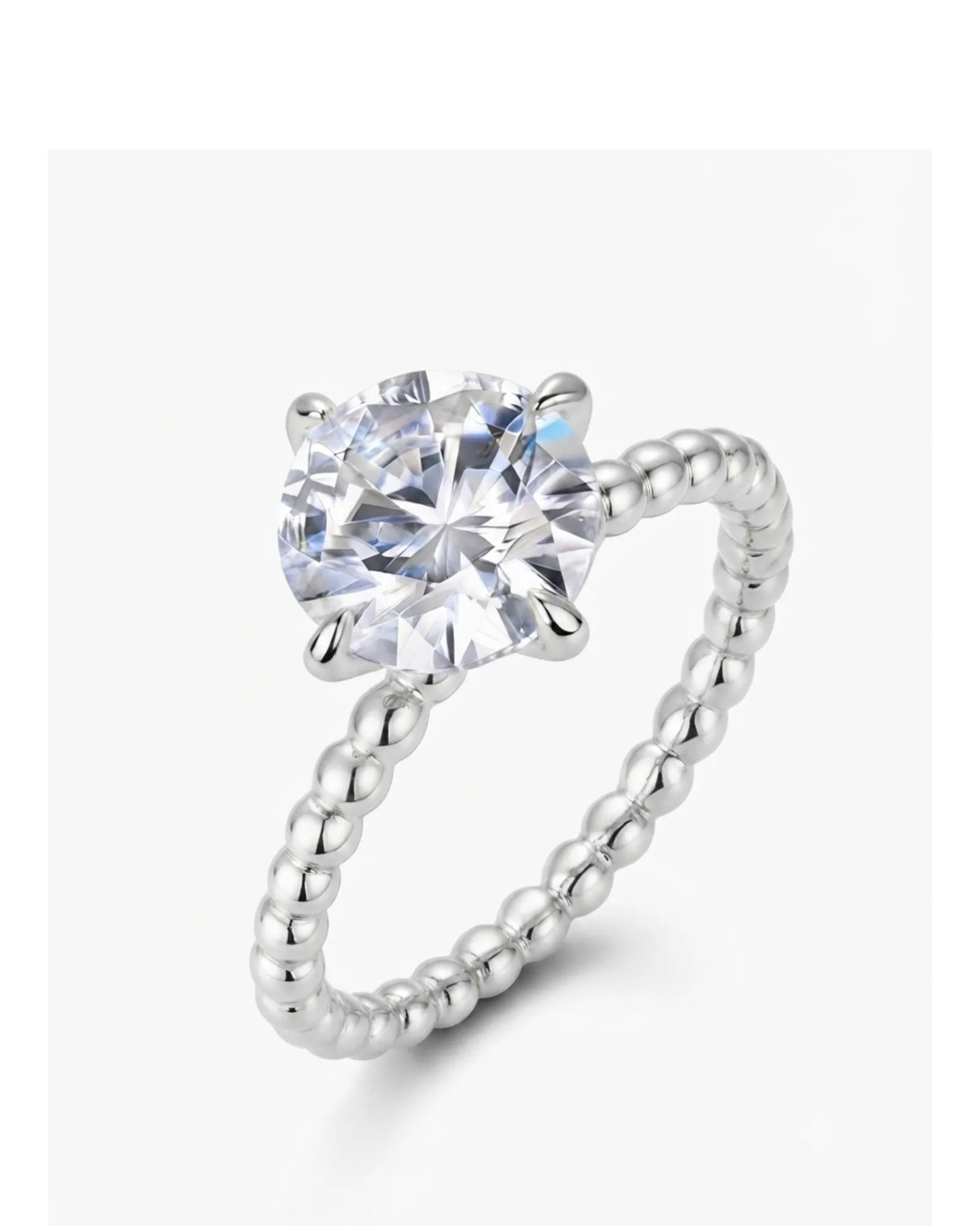 Platinum round moissanite engagement ring with polished beaded band and four-prong solitaire setting | SARATTI