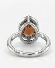 Protective pear-tip Topaz setting with open platinum gallery | SARATTI