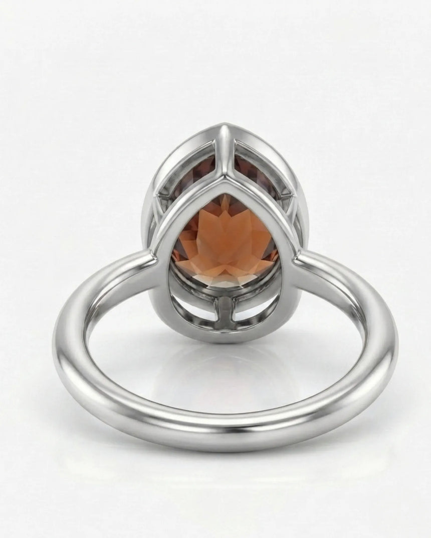 Protective pear-tip Topaz setting with open platinum gallery | SARATTI