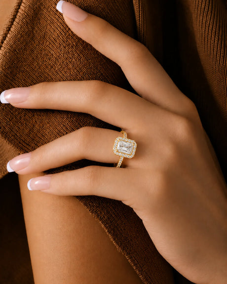 Radiant moissanite ring in yellow gold with four-prong center and rectangular halo | SARATTI