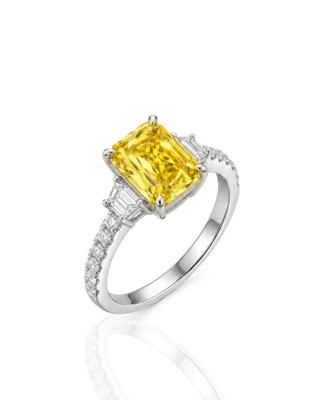 Radiant yellow sapphire ring with round and trapezoid diamonds in 18K white gold | SARATTI