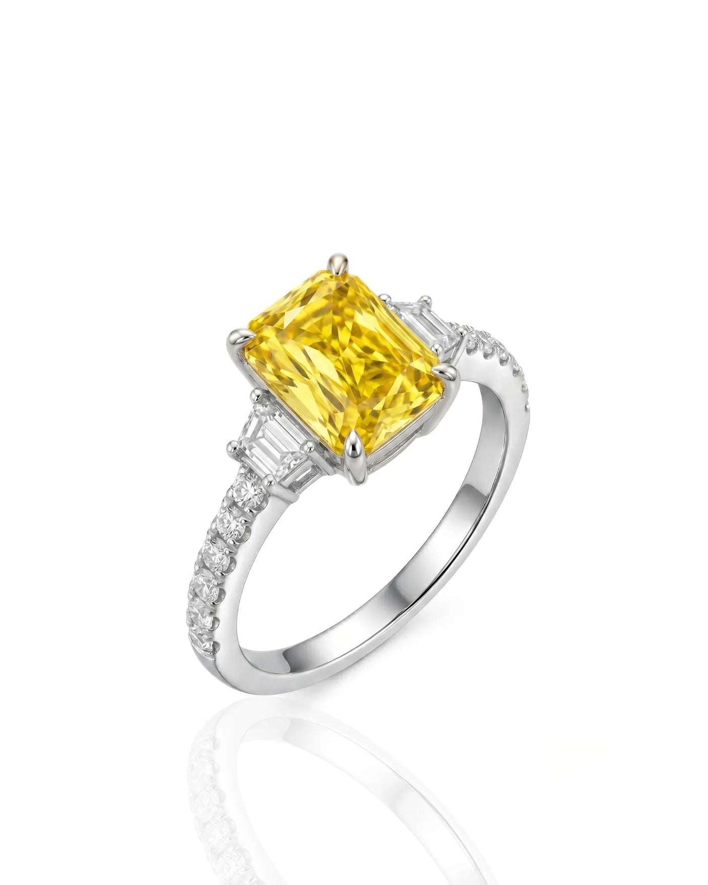 Radiant yellow sapphire ring with round and trapezoid diamonds in polished platinum | SARATTI