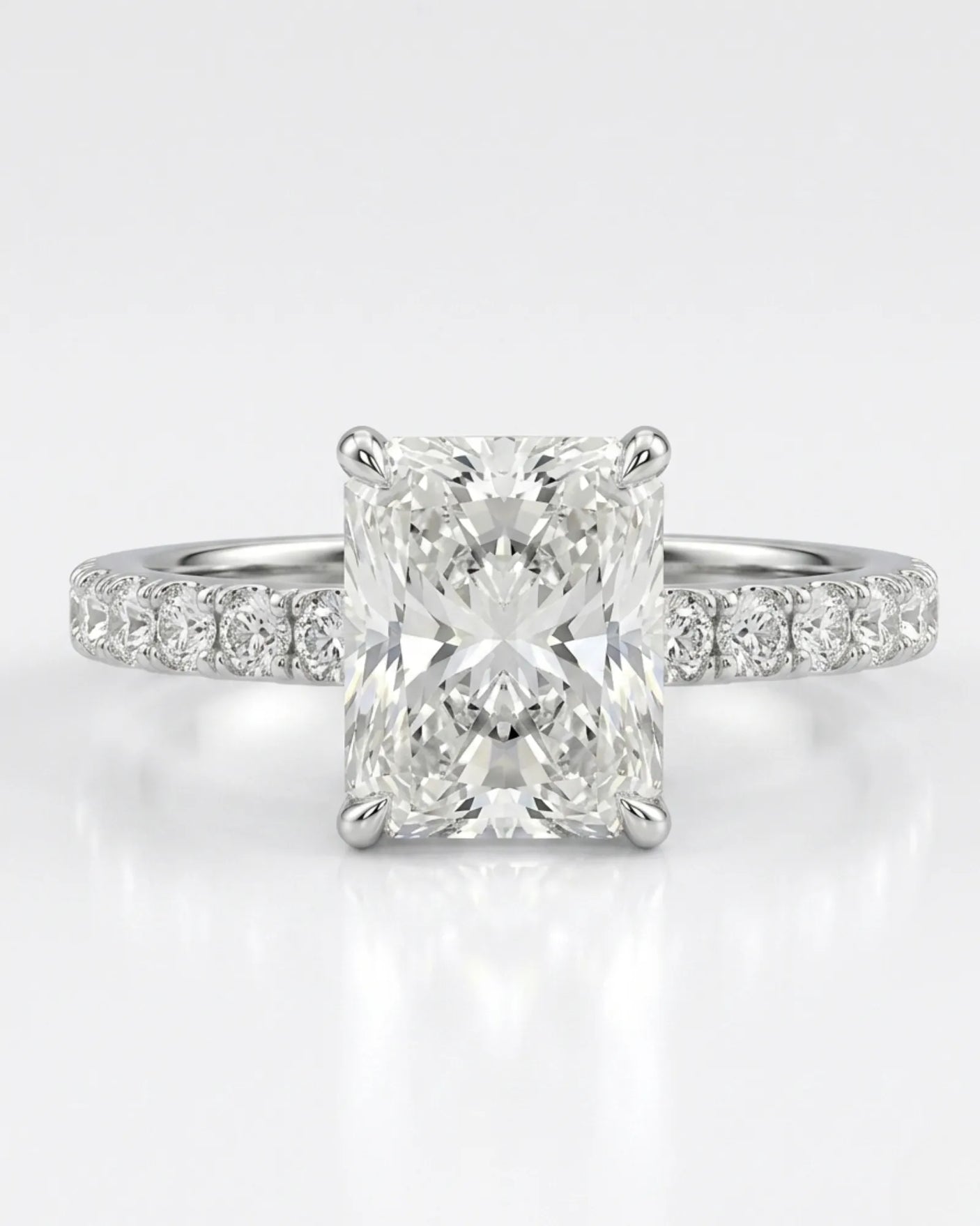 Rectangular radiant-cut natural diamond ring accented by pavé diamonds in refined polished platinum | SARATTI