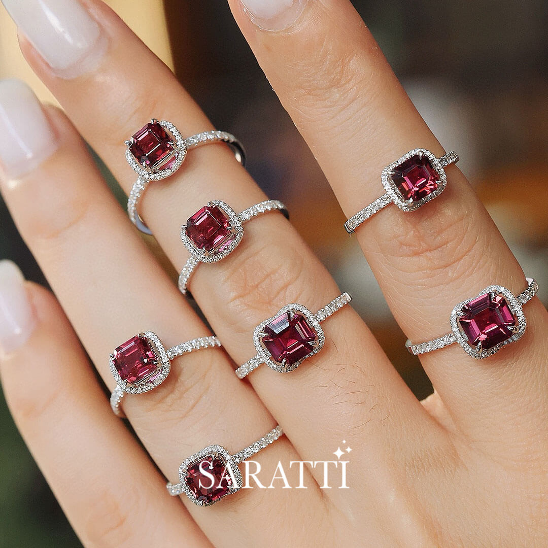 Model stacks seven of the White Gold  Regina Rouge Red Tourmaline and Diamond Rings on different fingers | Saratti Fine Jewelry 