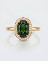 Rich forest green oval tourmaline ring framed by natural diamonds in 18K yellow gold | SARATTI