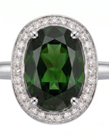 Rich forest green oval tourmaline ring framed by natural diamonds in platinum | SARATTI