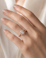 Romantic floral moissanite ring with oval center and crown-like halo in 18K rose gold | SARATTI