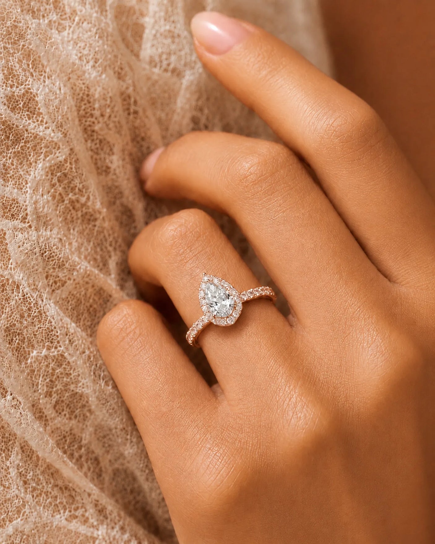 Romantic pear cut moissanite engagement ring with halo and pavé band in 18K rose gold | SARATTI