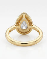 Romantic pear halo moissanite proposal ring with a slender pavé band in 18K yellow gold | SARATTI