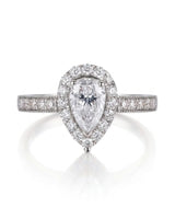 Romantic pear shaped moissanite ring with teardrop halo and pavé shoulders in platinum | SARATTI