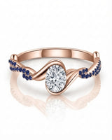 Romantic rose gold moissanite engagement ring with blue sapphire pavé for a distinctive proposal | SARATTI