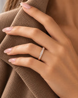 18K rose gold channel-set diamond wedding band shown on textured fabric | SARATTI