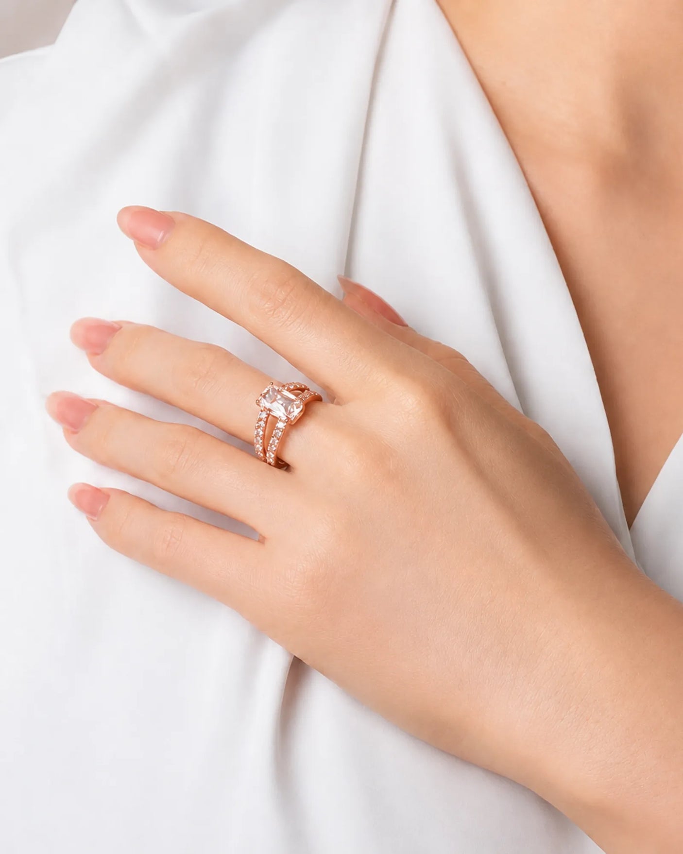 Rose gold emerald-cut moissanite engagement ring with pavé split shank and four-prong setting | SARATTI.