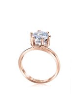 Rose gold moissanite engagement ring with round center stone and sculpted six-prong solitaire setting | SARATTI