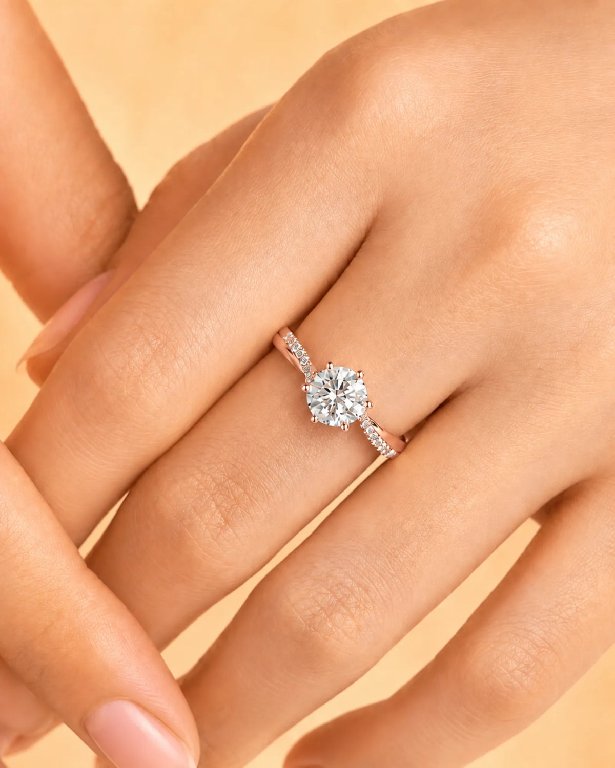 Round diamond engagement ring with pavé side stones and sculpted 18K rose gold band | SARATTI