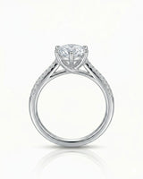 Round diamond engagement ring with six-prong center setting and pavé accents in platinum | SARATTI