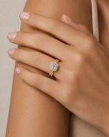 Round moissanite center stone ring with halo side stones in yellow gold | SARATTI