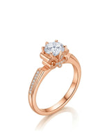Round moissanite engagement ring with fleur-de-lis gallery, pavé accents, and romantic 18K rose gold setting | SARATTI