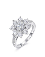 Round moissanite engagement ring with floral cluster halo and pavé shoulders in polished platinum | SARATTI