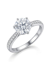 Round moissanite engagement ring with six prongs and pavé shoulder stones crafted in platinum | SARATTI