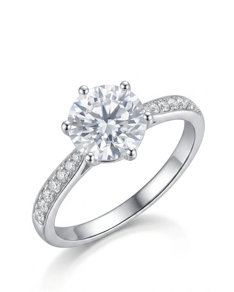 Round moissanite engagement ring with six prongs and pavé shoulder stones in 18K white gold | SARATTI