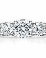 Round moissanite platinum ring featuring side stones, pavé shoulders, and gallery accent | SARATTI