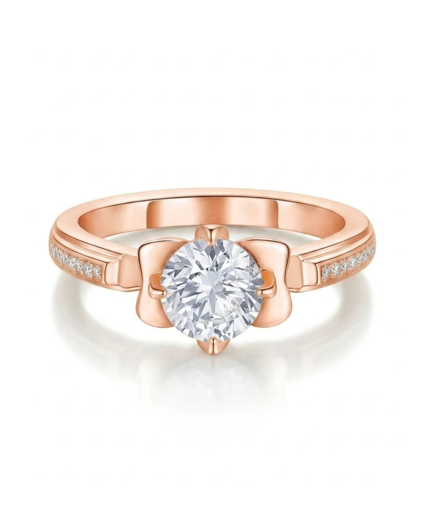 Round moissanite proposal ring with pavé side stones and symbolic fleur-de-lis setting in 18K rose gold | SARATTI