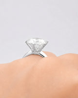 Round moissanite ring in platinum with elevated crown and minimalist solitaire profile | SARATTI