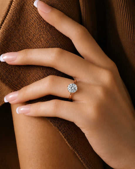 Round moissanite ring in rose gold with polished band and open gallery design | SARATTI