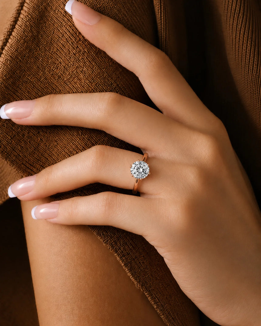 Round moissanite ring in rose gold with polished band and open gallery design | SARATTI