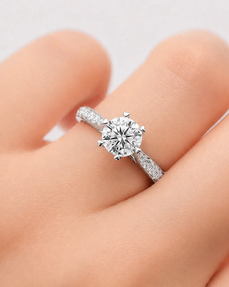 Round moissanite ring with sculpted white gold setting and sweeping accent-set band | SARATTI