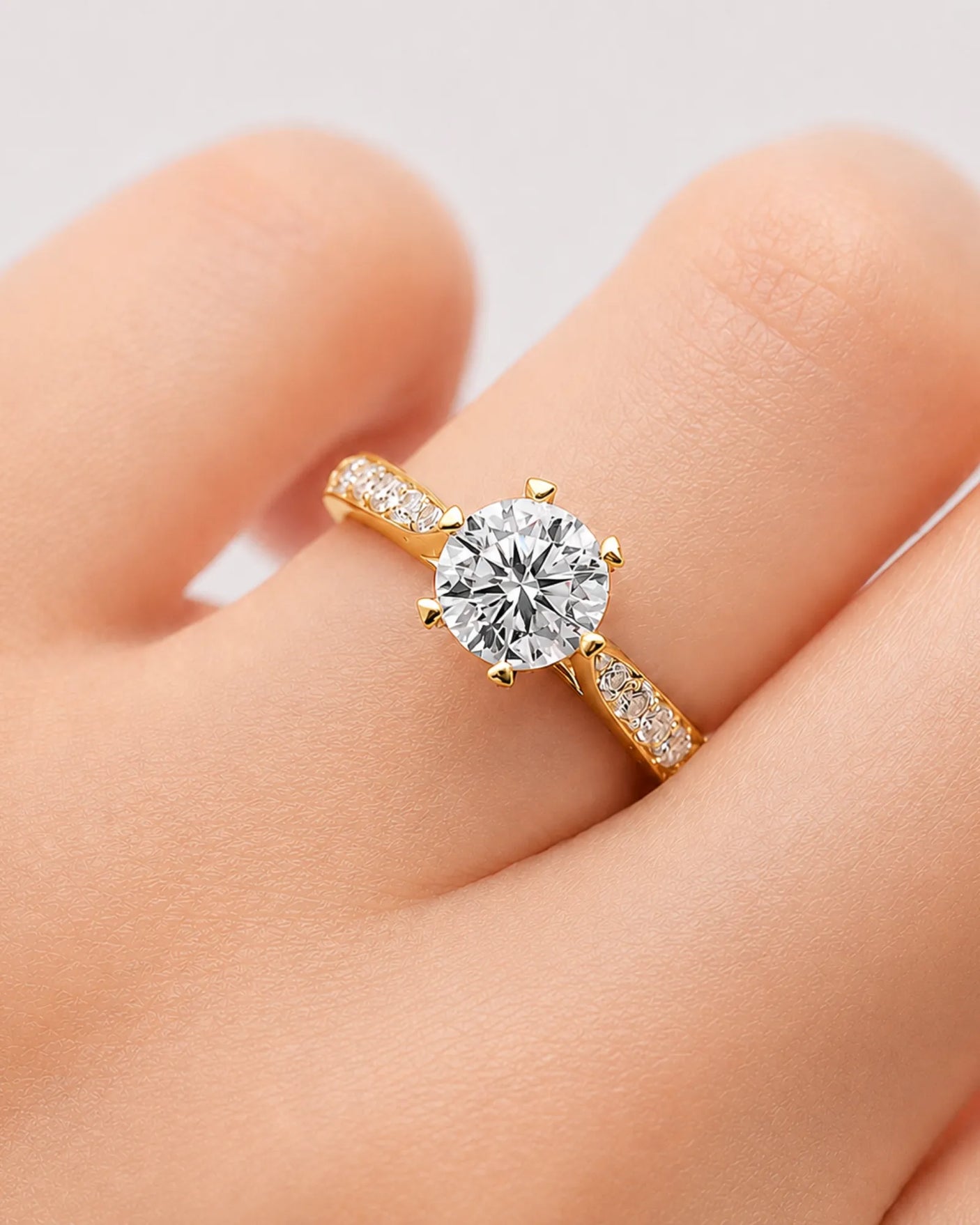 Round moissanite ring with sweeping yellow gold band and concealed gallery detailing | SARATTI
