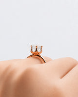 Round moissanite solitaire ring in 18K rose gold with tulip-inspired crown and polished band | SARATTI