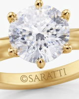Round moissanite solitaire ring in 18K yellow gold with tulip-inspired crown and polished band | SARATTI