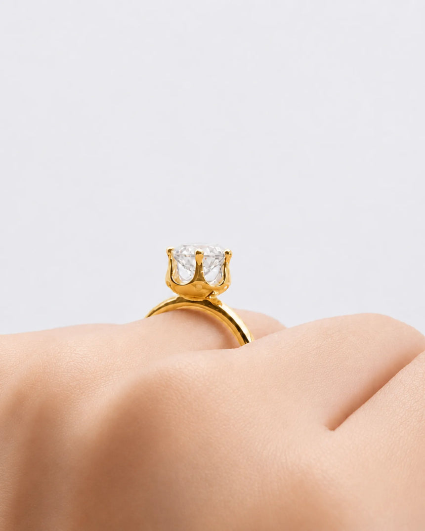 Round moissanite solitaire ring in 18K yellow gold with tulip-inspired crown and polished band | SARATTI