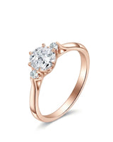 Round moissanite three stone engagement ring with sculptural rose gold setting | SARATTI