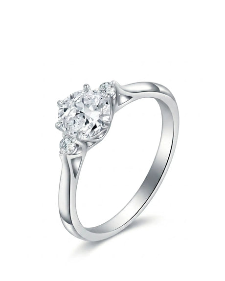 Round moissanite three stone engagement ring with sculptural white gold setting | SARATTI