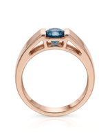 Round treated blue diamond displayed without side stones against polished 18K rose gold | SARATTI