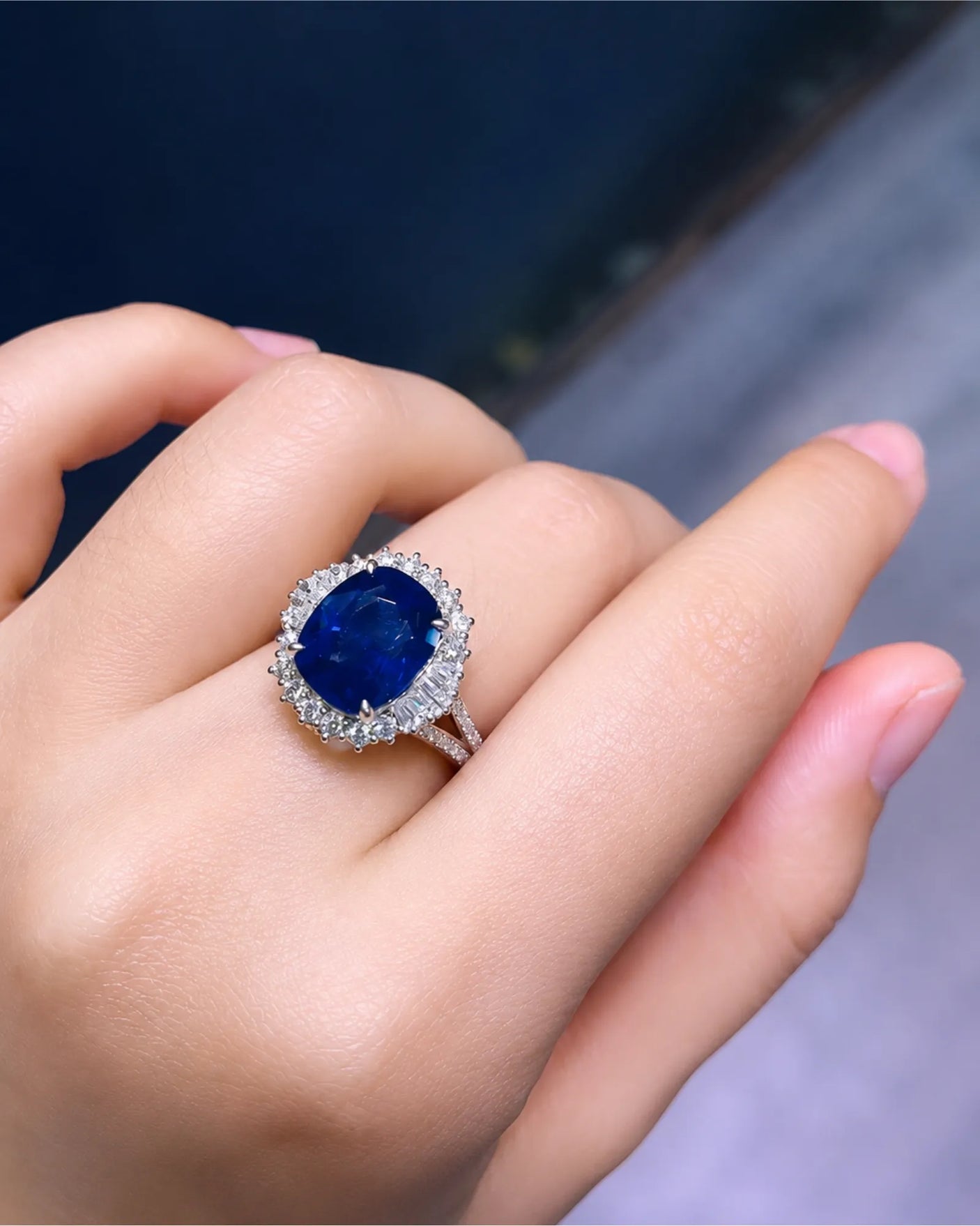Royal blue cushion sapphire takes center stage within a bright platinum diamond frame | SARATTI