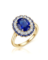 Royal blue oval sapphire ring with diamond and sapphire double halo in 18K yellow gold | SARATTI