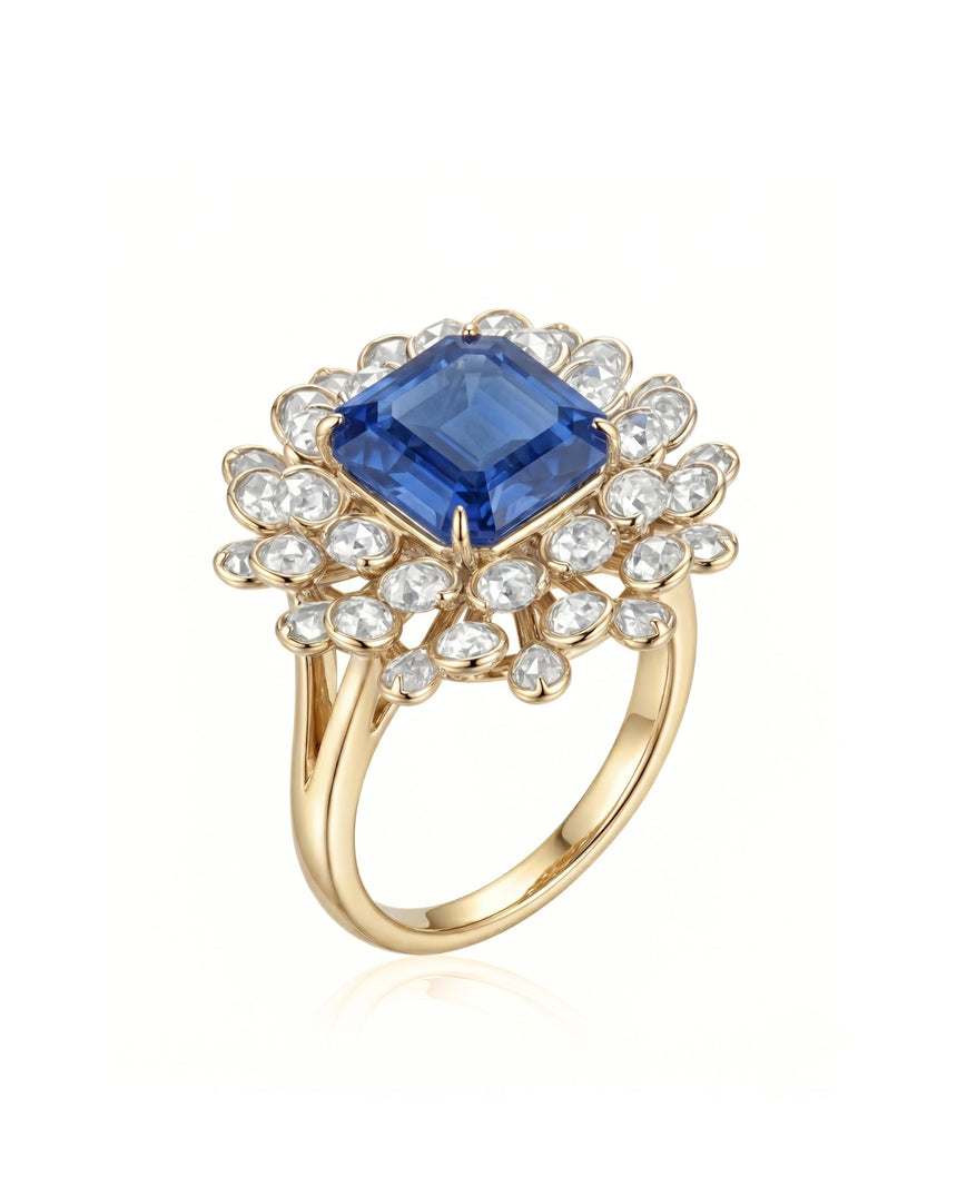 Royal blue sapphire ring with emerald-cut center and diamond floral halo in 18K yellow gold | SARATTI